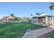 Green lawn with a refreshing pool, sunshades, lounge chairs, and lush surroundings at 1040 E Osborn Rd # 501, Phoenix, AZ 85014