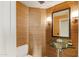 Unique powder room features a vessel sink, modern lighting, textured wallpaper, and luxury fixtures at 1040 E Osborn Rd # 501, Phoenix, AZ 85014