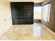 Room featuring large shelving unit and picture window, complemented by stone tiled flooring at 1040 E Osborn Rd # 501, Phoenix, AZ 85014
