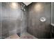 Modern walk-in shower with black tile surround and dual shower heads at 1040 E Osborn Rd # 501, Phoenix, AZ 85014