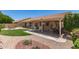 Lush backyard featuring a manicured lawn, stone patio, and well-maintained landscaping at 11206 W Sieno Pl, Avondale, AZ 85392