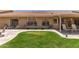Spacious backyard with a covered patio, a well-manicured lawn, and room for entertaining at 11206 W Sieno Pl, Avondale, AZ 85392