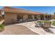 View of the backyard with patio furniture on a stone patio and chaise lounges at 11206 W Sieno Pl, Avondale, AZ 85392
