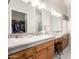 Bathroom featuring a double sink vanity and walk-in closet at 11206 W Sieno Pl, Avondale, AZ 85392