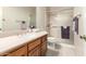 Bathroom with vanity, toilet and shower in neutral tones at 11206 W Sieno Pl, Avondale, AZ 85392