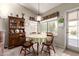 Cozy dining area with charming decor, a window with a view, and comfortable seating at 11206 W Sieno Pl, Avondale, AZ 85392