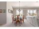 Bright dining room with a table set for six and natural light at 11206 W Sieno Pl, Avondale, AZ 85392