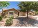 Landscaped front yard of the home features desert landscaping, and mature trees at 11206 W Sieno Pl, Avondale, AZ 85392