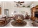 Comfortable living room with a plush sofa, ceiling fan, and decorative accents at 11206 W Sieno Pl, Avondale, AZ 85392