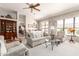 Bright living room featuring large windows, neutral tones, and comfortable seating at 11206 W Sieno Pl, Avondale, AZ 85392