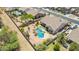 An overhead view of the backyard featuring a pool, lush landscaping, and a covered patio at 11312 E Enrose St, Mesa, AZ 85207
