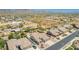 An aerial view showcasing homes near desert vegetation and a horse property in a well-maintained neighborhood at 11312 E Enrose St, Mesa, AZ 85207