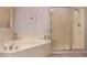 Bathroom features a soaking tub and glass enclosed shower at 11312 E Enrose St, Mesa, AZ 85207