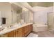 Bathroom features double sinks, a soaking tub, and a glass-enclosed shower at 11312 E Enrose St, Mesa, AZ 85207