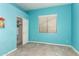 A bedroom with light blue walls features a closet and a window with horizontal blinds at 11312 E Enrose St, Mesa, AZ 85207
