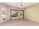 Bright bedroom with neutral carpet, accent walls and two large windows at 11312 E Enrose St, Mesa, AZ 85207