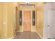 Entry way features wood flooring, a light fixture, and a wooden front door with side windows at 11312 E Enrose St, Mesa, AZ 85207