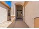 Front porch features stone flooring and a wood door, with a peek of the interior at 11312 E Enrose St, Mesa, AZ 85207