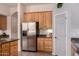 Kitchen with stainless steel refrigerator and light wood cabinetry at 11312 E Enrose St, Mesa, AZ 85207