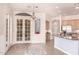 Bright eat-in kitchen features light wood floors, granite counters, and French doors to the backyard at 11312 E Enrose St, Mesa, AZ 85207