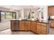 Kitchen island with wood cabinets, stainless steel dishwasher and faucet at 11312 E Enrose St, Mesa, AZ 85207
