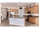 Spacious kitchen features light wood cabinetry, granite countertops, stainless appliances, and a large island at 11312 E Enrose St, Mesa, AZ 85207