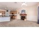 View of living room area and kitchen featuring carpet flooring and a fireplace at 11312 E Enrose St, Mesa, AZ 85207