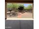 View of the backyard from the covered patio with desert landscaping and fire pit area at 1241 E Palo Verde Dr, Casa Grande, AZ 85122