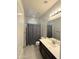 Well-lit bathroom with a combination shower/tub, vanity with sink and dark cabinets at 1241 E Palo Verde Dr, Casa Grande, AZ 85122