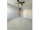 Bright bedroom featuring tile flooring, ceiling fan, and sliding door closet at 1241 E Palo Verde Dr, Casa Grande, AZ 85122