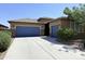Charming single-story home with a desert-landscaped front yard, blue garage doors, and stone accents at 1241 E Palo Verde Dr, Casa Grande, AZ 85122