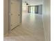 Hallway featuring tiled floors leads to an open living area with a sliding glass door at 1241 E Palo Verde Dr, Casa Grande, AZ 85122