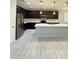 Modern kitchen features dark cabinets, stainless steel appliances, white countertops, and pendant lighting at 1241 E Palo Verde Dr, Casa Grande, AZ 85122