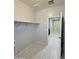 Functional laundry room with built-in shelving, tile floors, and utility connections at 1241 E Palo Verde Dr, Casa Grande, AZ 85122