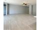 Large living room features neutral paint, wood look tile flooring and modern ceiling fan at 1241 E Palo Verde Dr, Casa Grande, AZ 85122