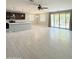 Open-concept living room with tile floors, sliding glass doors to backyard and modern ceiling fan at 1241 E Palo Verde Dr, Casa Grande, AZ 85122
