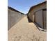 Long side yard with gravel, block fence, shed, and narrow space at 1241 E Palo Verde Dr, Casa Grande, AZ 85122