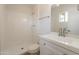 Updated bathroom includes a tiled walk-in shower and a modern vanity with a mirror at 1310 E Ironwood Dr, Buckeye, AZ 85326
