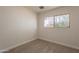 A cozy bedroom with carpet and a window offering natural light at 1310 E Ironwood Dr, Buckeye, AZ 85326