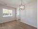 Bright dining room offers an updated light fixture, a window view to the front yard, and new flooring at 1310 E Ironwood Dr, Buckeye, AZ 85326