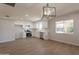 Open-concept kitchen features modern lighting, white cabinets, stainless appliances and new laminate flooring at 1310 E Ironwood Dr, Buckeye, AZ 85326