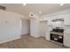 Updated kitchen featuring modern white cabinets, stainless steel appliances, and wood look laminate flooring at 1310 E Ironwood Dr, Buckeye, AZ 85326