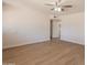Bright living room features fresh paint, ceiling fan, and new wood-look laminate flooring at 1310 E Ironwood Dr, Buckeye, AZ 85326