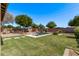 A backyard featuring a pool, patio, xeriscaping and green space at 1405 E Aloe Dr, Chandler, AZ 85286