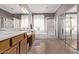 Bright bathroom with a large mirror, a dual vanity, and a glass-enclosed shower at 1405 E Aloe Dr, Chandler, AZ 85286