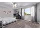 Bedroom with modern floors, ceiling fan, and a large window allowing for natural light at 1405 E Aloe Dr, Chandler, AZ 85286