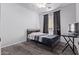 Bedroom with dark gray flooring, a bed, and natural light from the window at 1405 E Aloe Dr, Chandler, AZ 85286