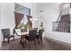 Dining area with tall ceilings, dark wood table set and a large window with window treatments at 1405 E Aloe Dr, Chandler, AZ 85286