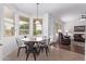 Bright dining area with natural light, stylish table and chairs, and views of the living room at 1405 E Aloe Dr, Chandler, AZ 85286