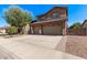 Spacious driveway leads to a home with a three-car garage and well-maintained landscaping at 1405 E Aloe Dr, Chandler, AZ 85286